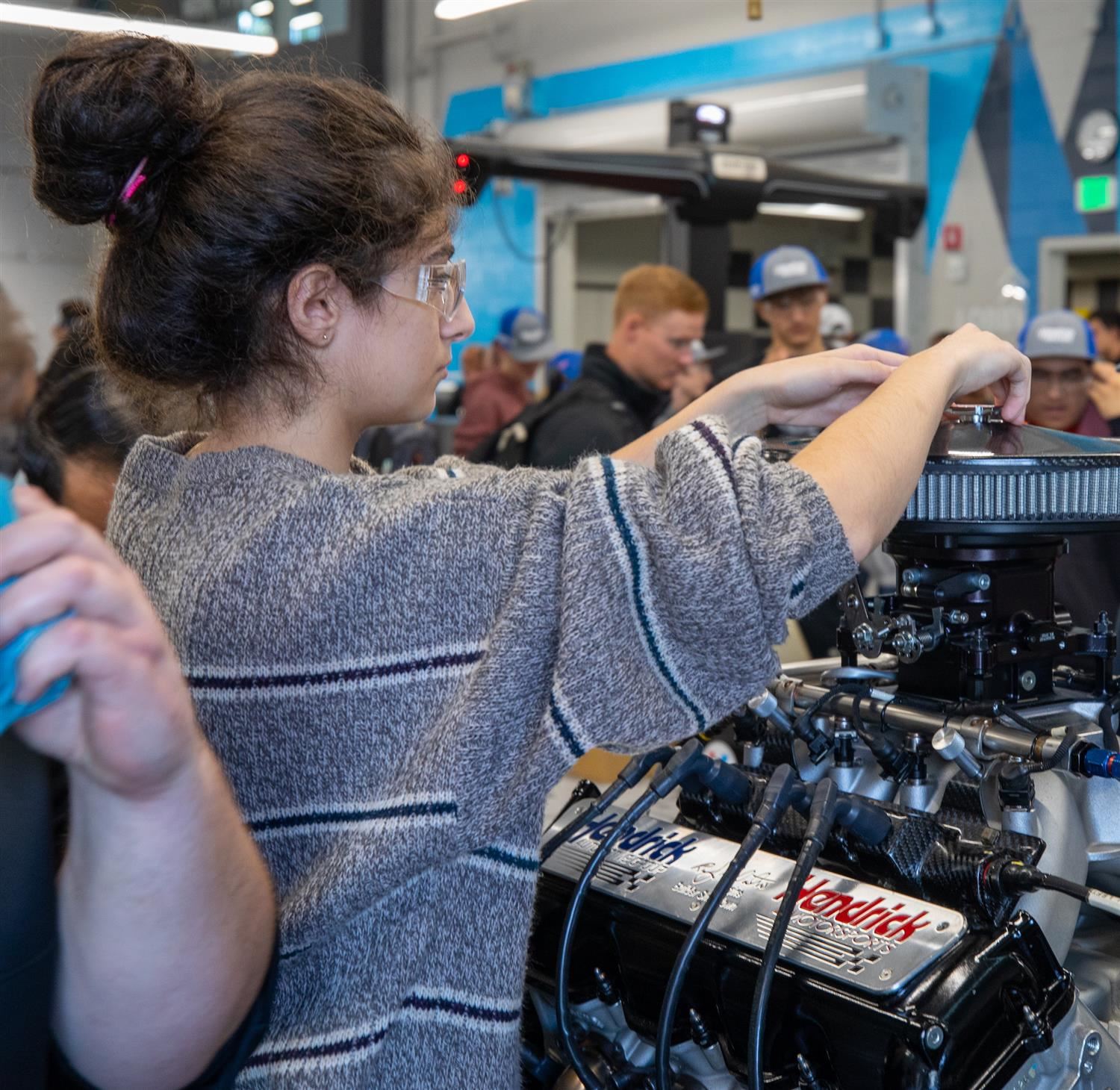  Student from Vernon Malone Early College works on a race car engine